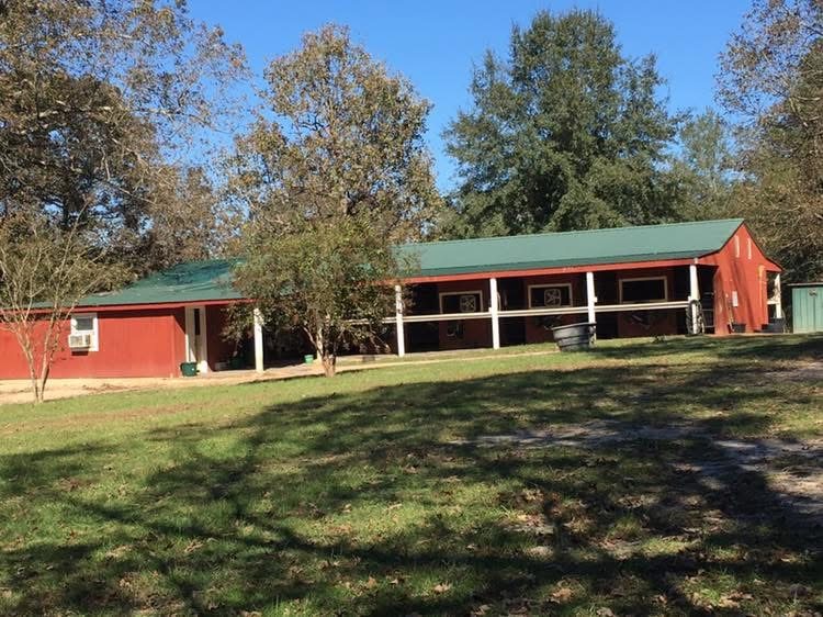Red barn exterior and stalls at Merry Go Round Farm