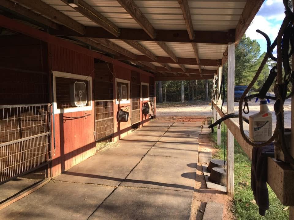 Barn exterior walkway and stalls at Merry Go Round Farm